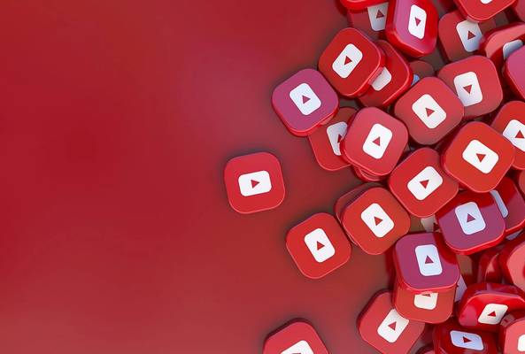 Pile of red YouTube play button icons on a red background for video streaming concept