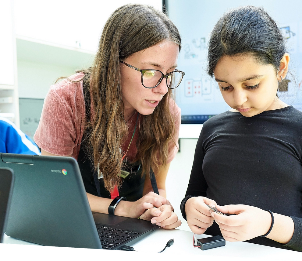 teacher helping pupil to explore the micro:bit 