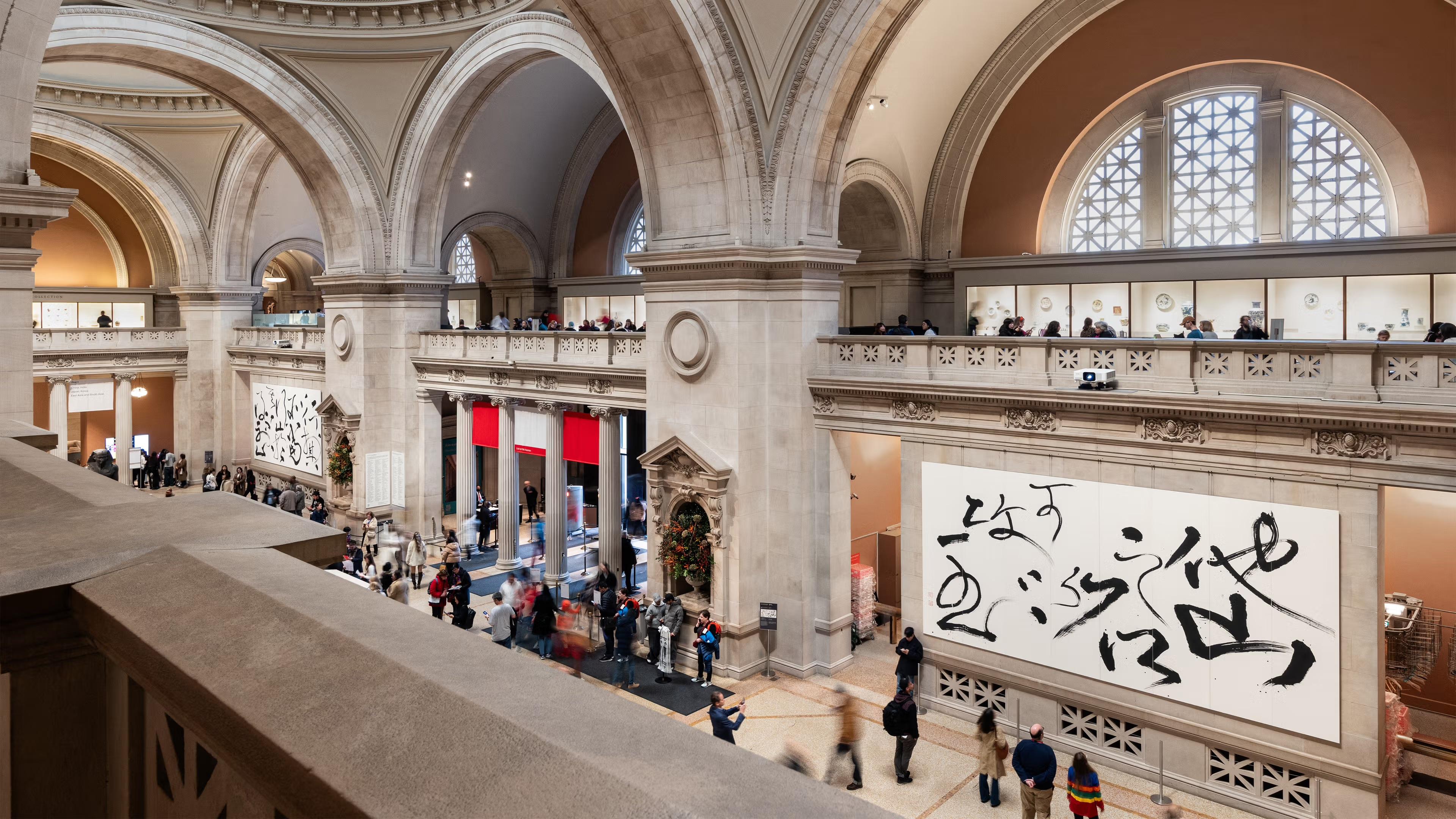Photo image of The Great Hall of the Met, with hanging calligraphy paintings 