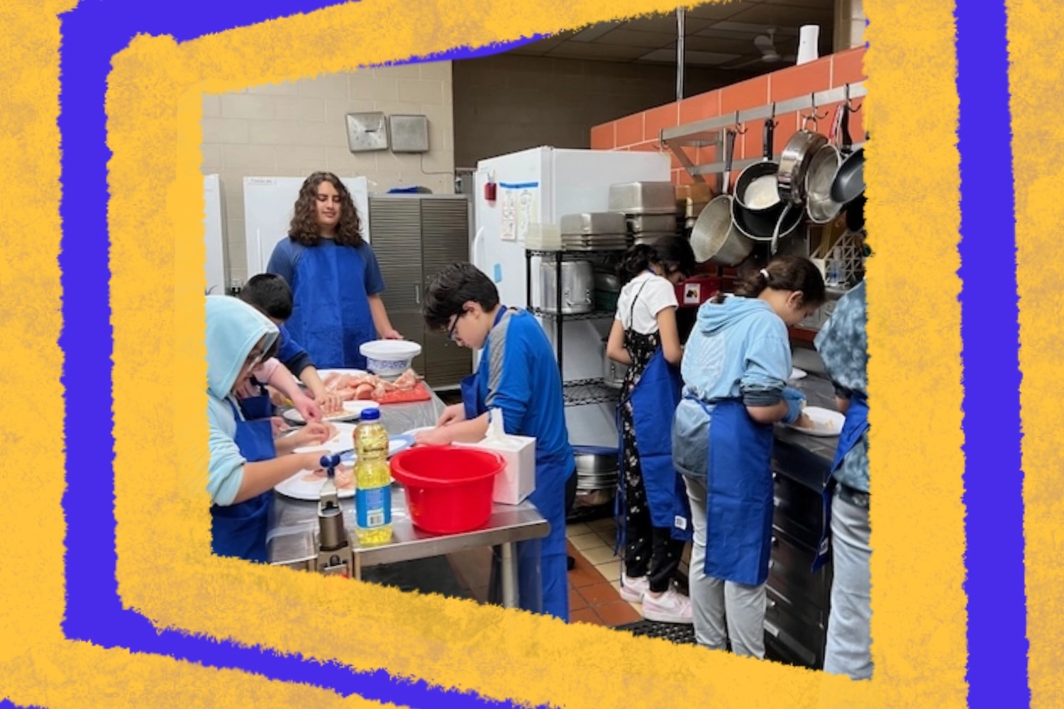 A group of volunteers in blue aprons is engaged in food preparation in a kitchen setting, demonstrating community service and teamwork. They are actively participating in a civic learning program that emphasizes leadership and volunteer opportunities.