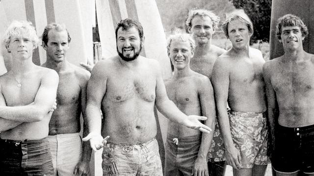 John Milius (center) on Big Wednesday set