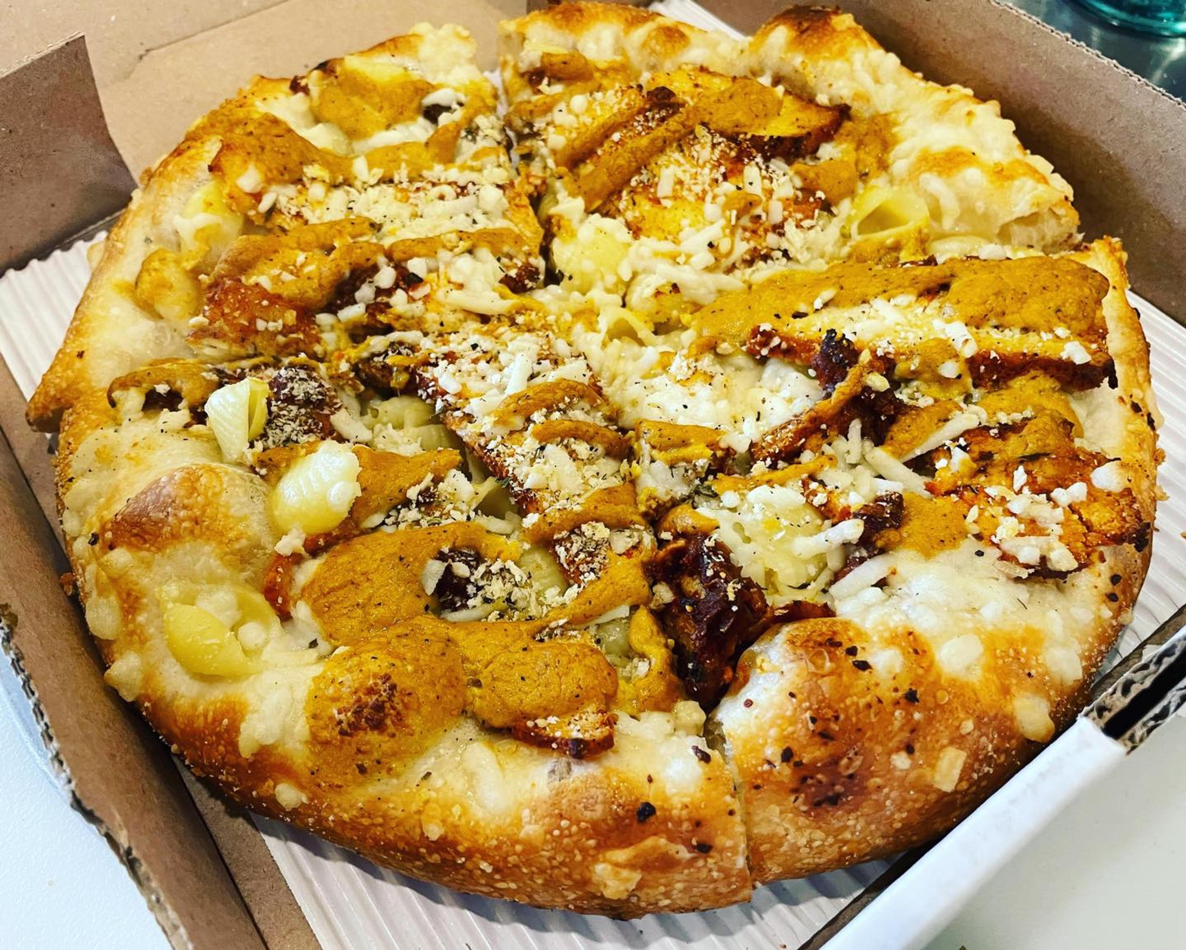 the Shell Raiser: garlic oil, Follow Your Heart mozzarella, shell pasta, cashew mac and cheese sauce, tofu bacon, toasted breadcrumbs.