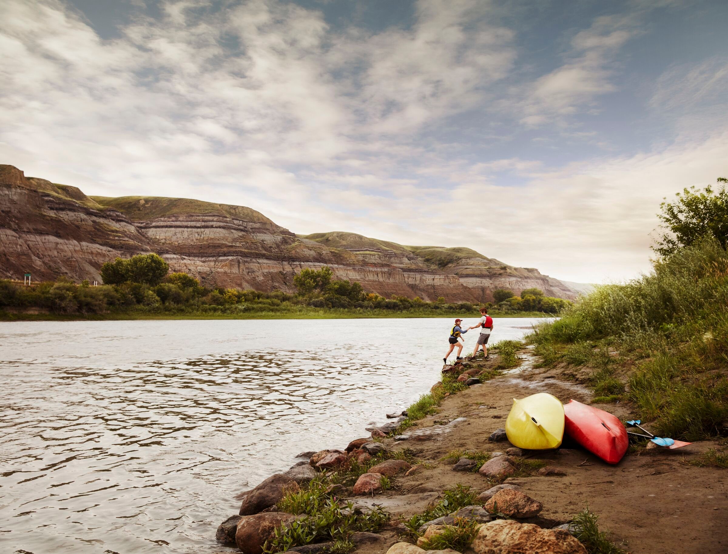 Couple along the Red Deer River with their kayaks.